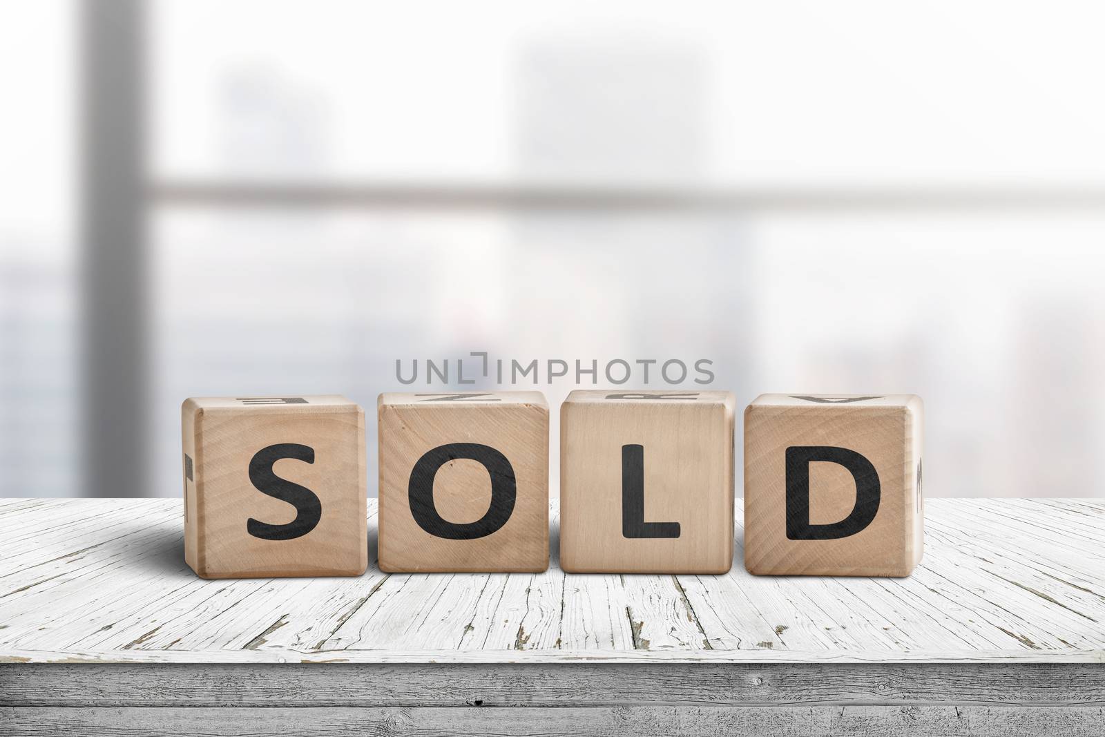 Sold sign on a wooden table by Sportactive