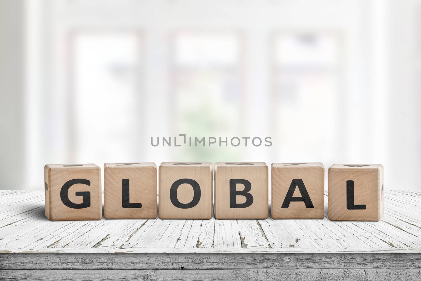 Global sign made of wood in a bright room on a white desk with worn paint