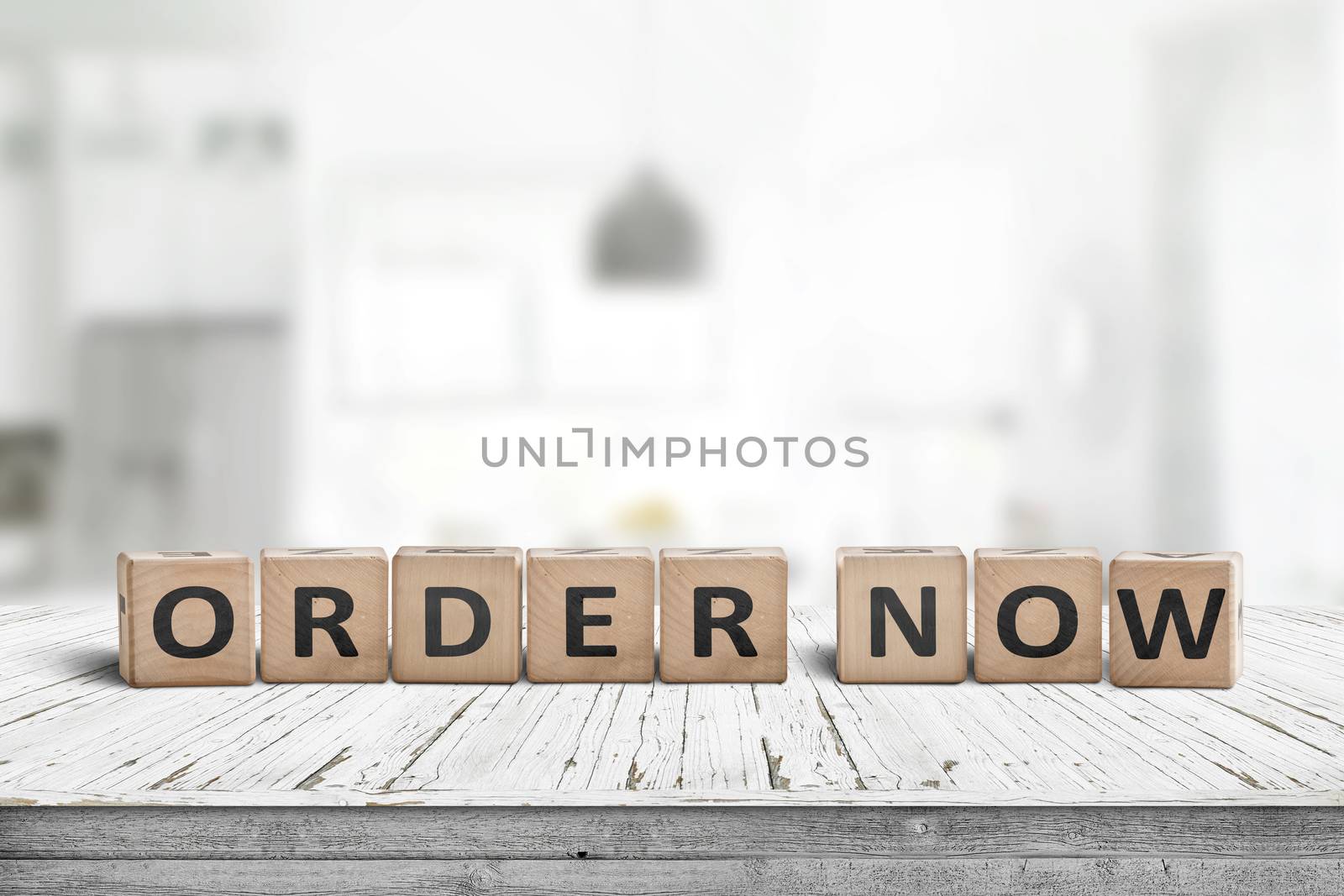 Order now sign on a wooden table in a brigh living room with interiors