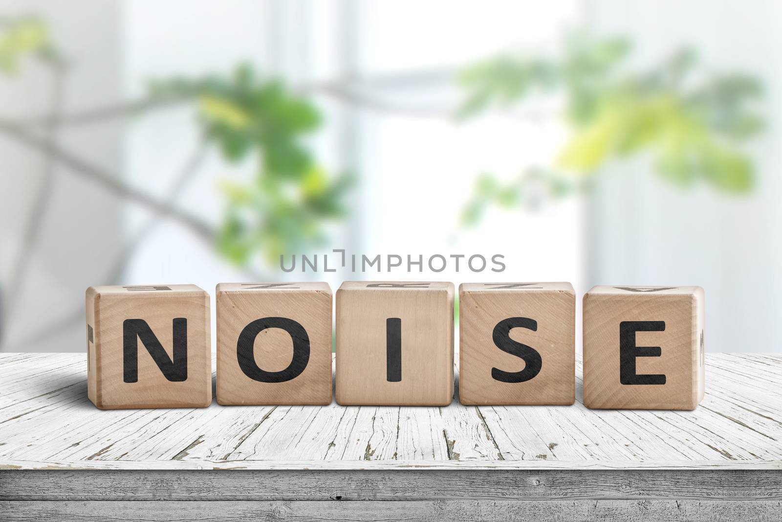 Noise sign made of wood in a bright room with green plants in daylight