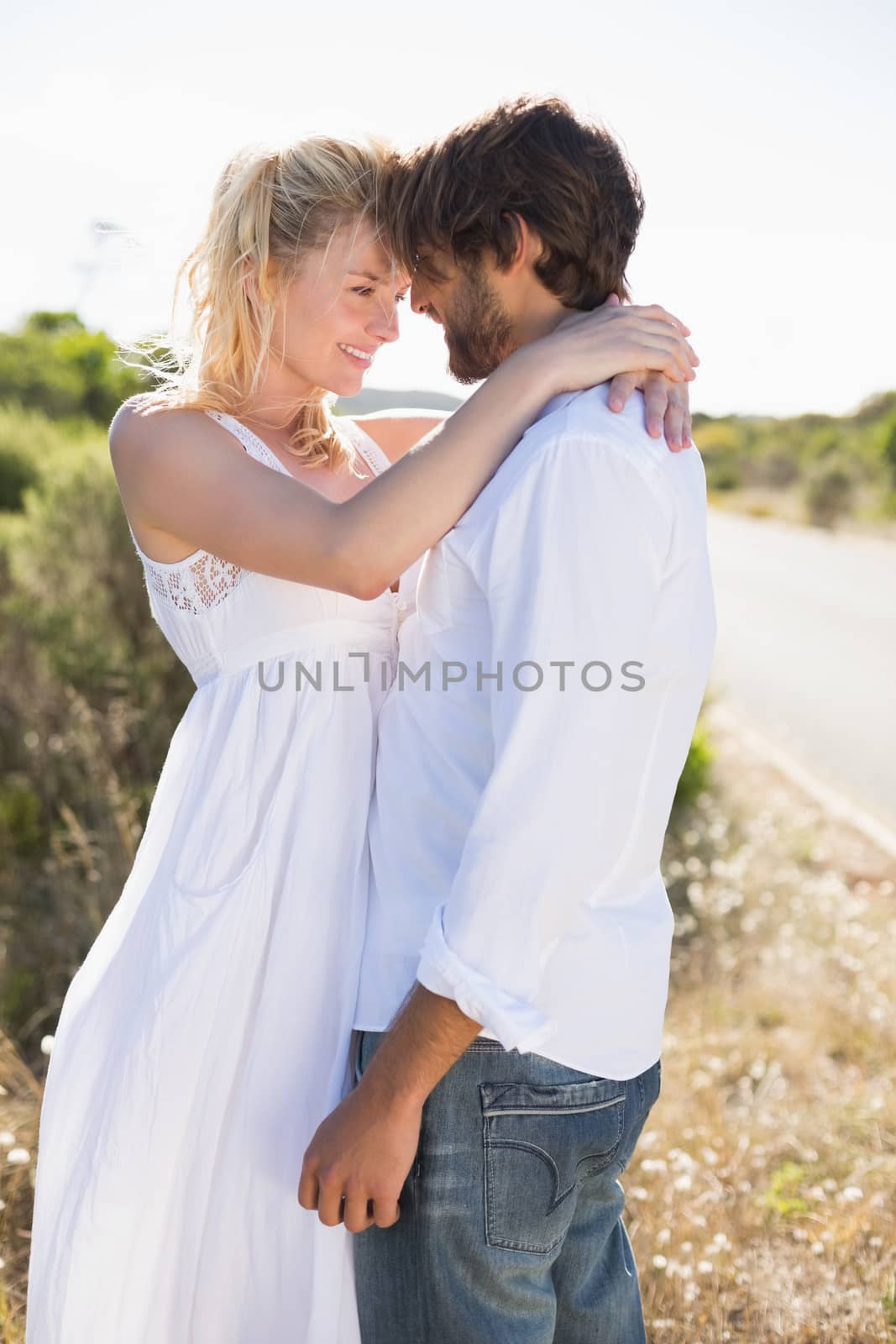 Attractive couple embracing by the road by Wavebreakmedia