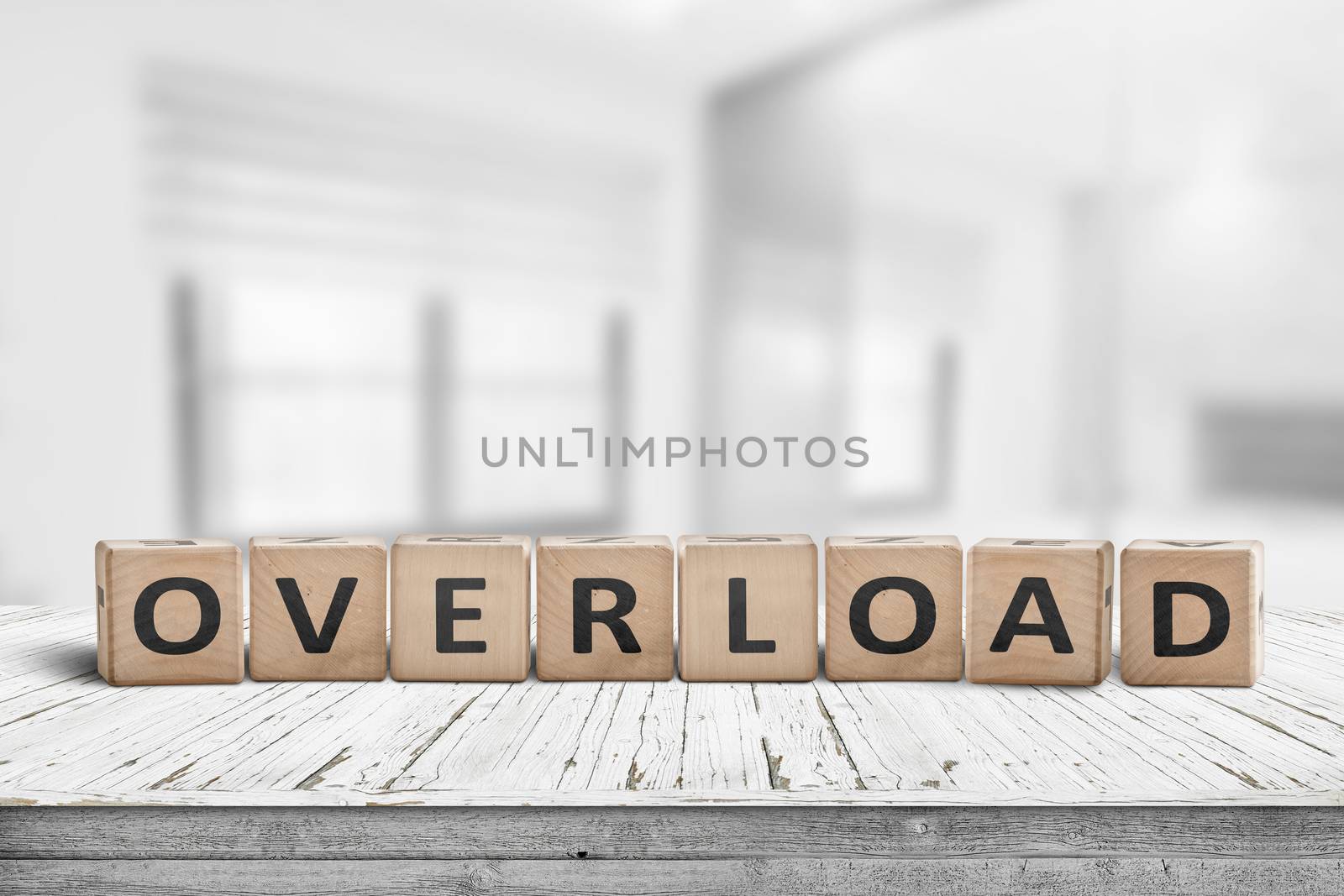 Sign with the word overload in a bright office by Sportactive