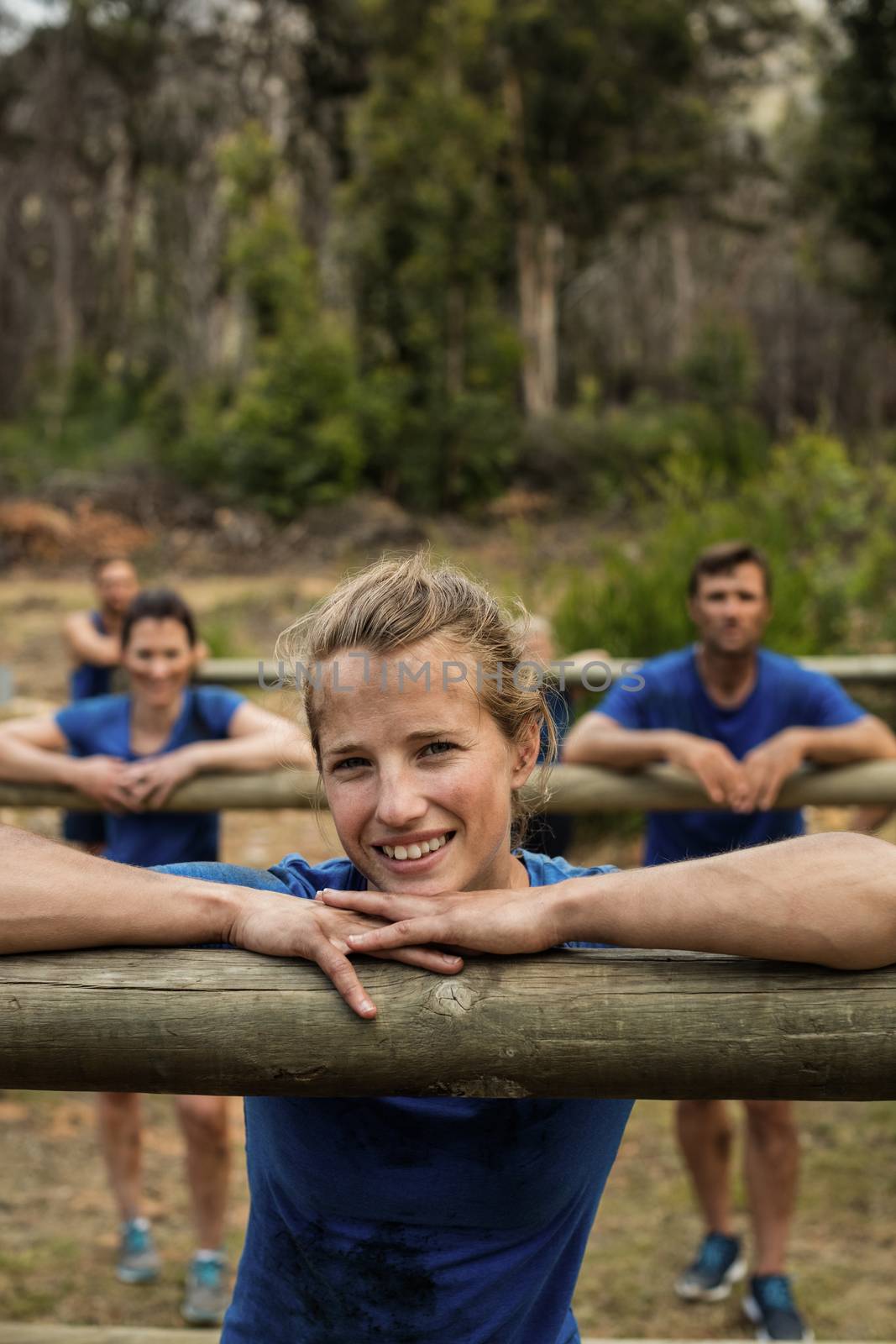 People leaning on hurdles during obstacle training by Wavebreakmedia