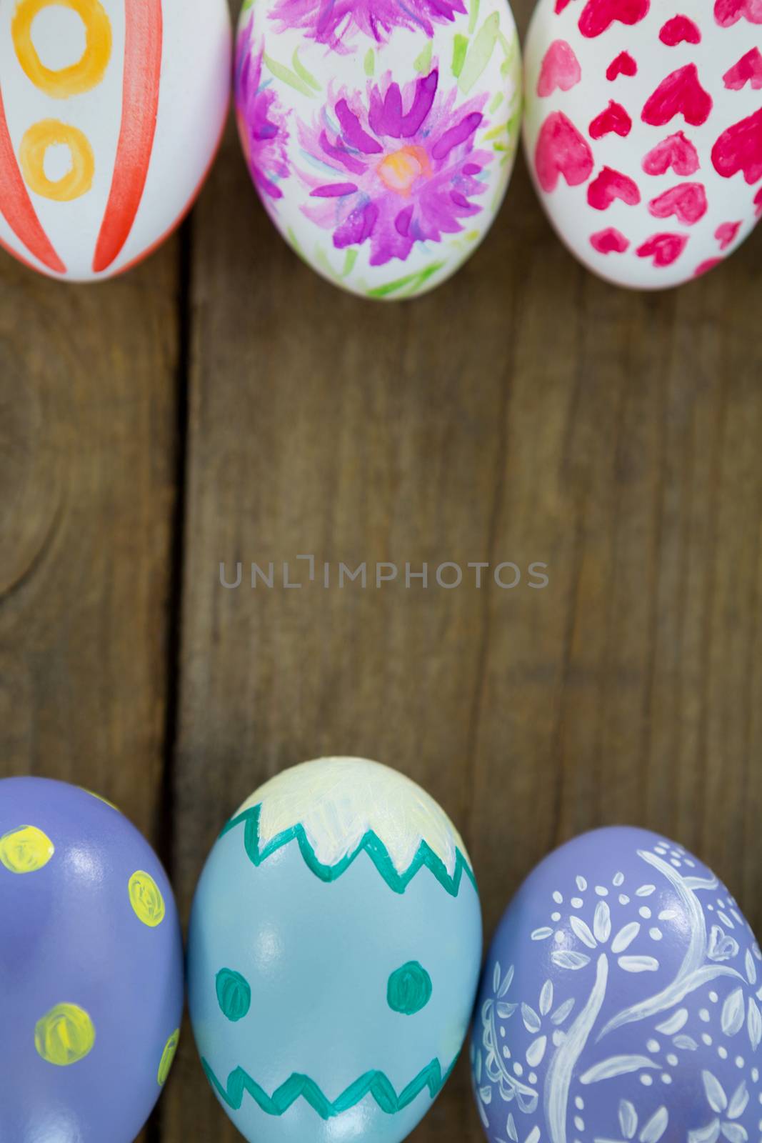 Painted Easter eggs on wooden surface