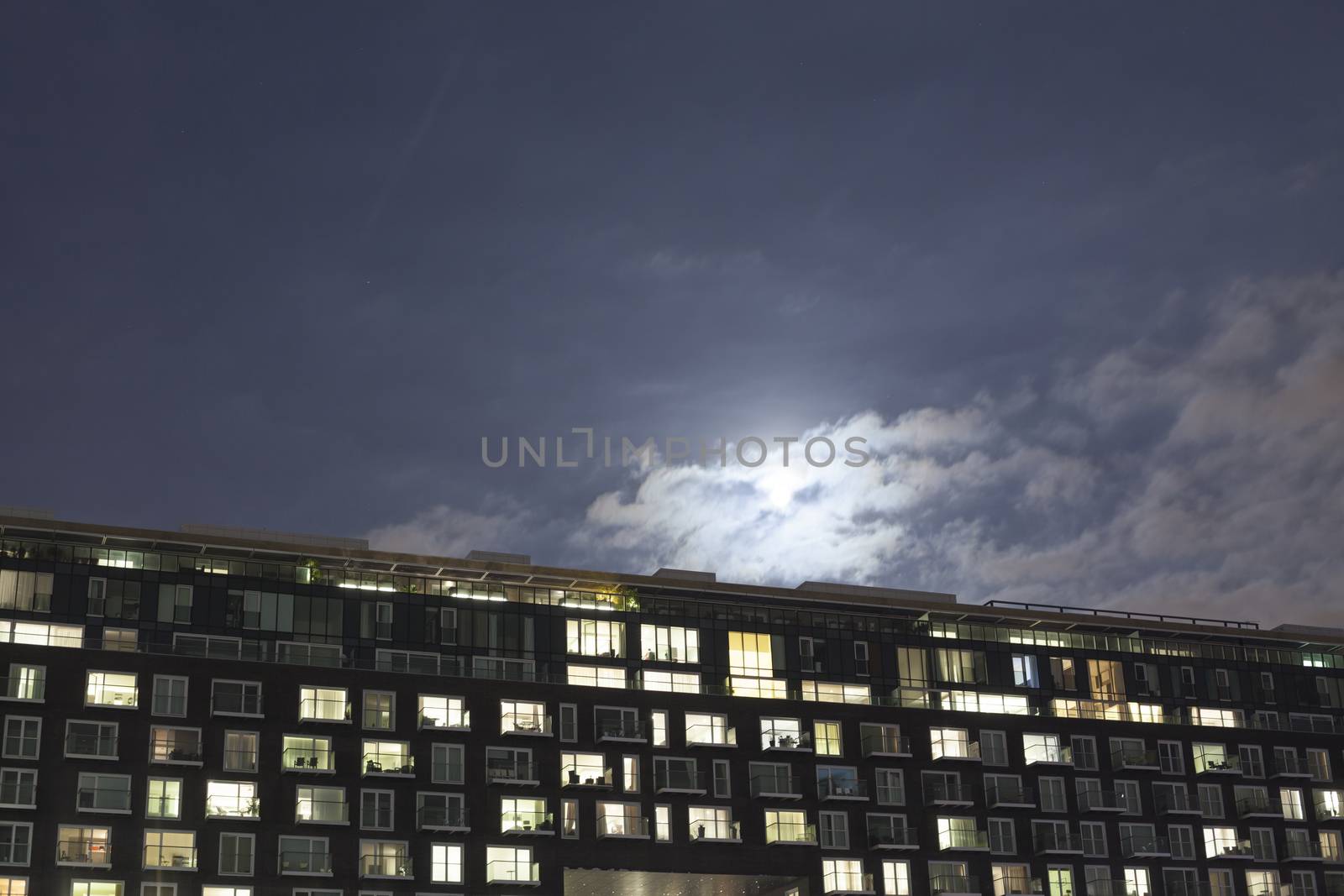 Modern apartment building at dusk by conceptualmotion