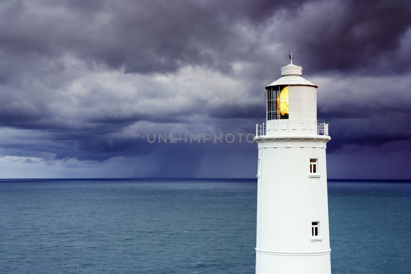 Lighthouse against stormy sky by conceptualmotion