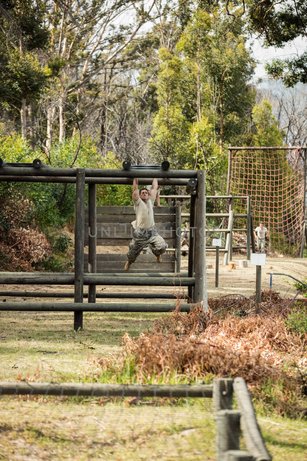 Soldier running through obstacle course in boot camp