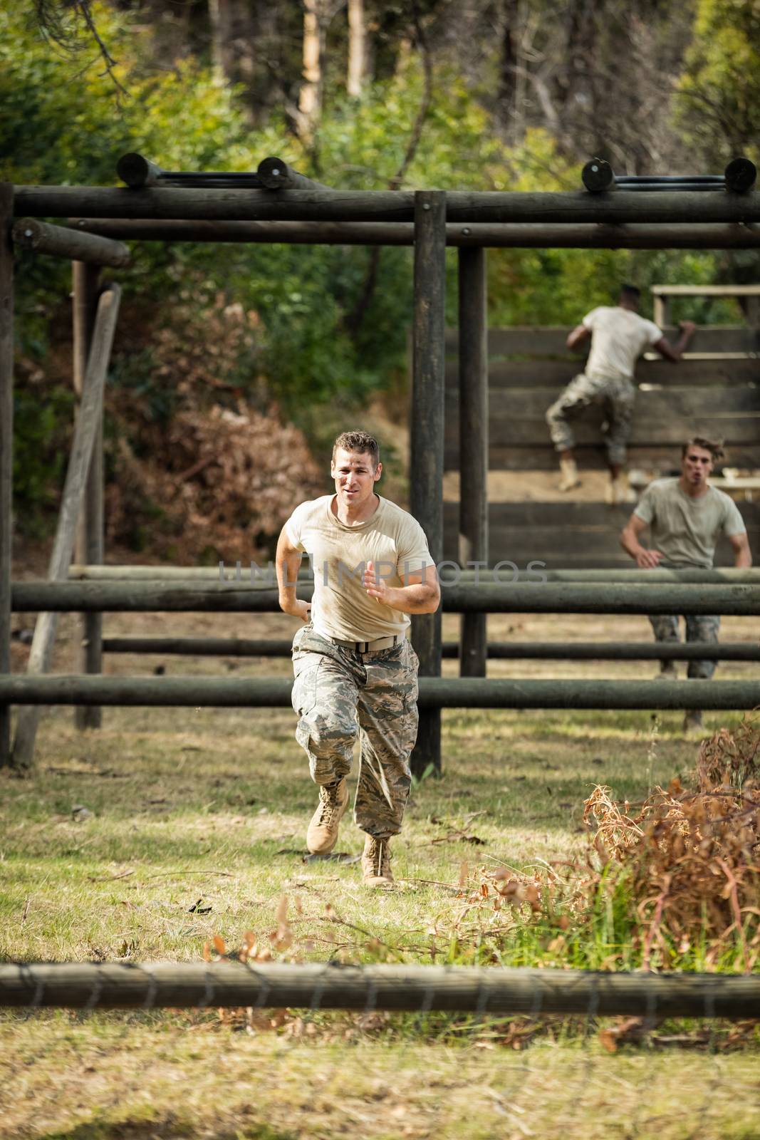 Soldier running through obstacle course in boot camp