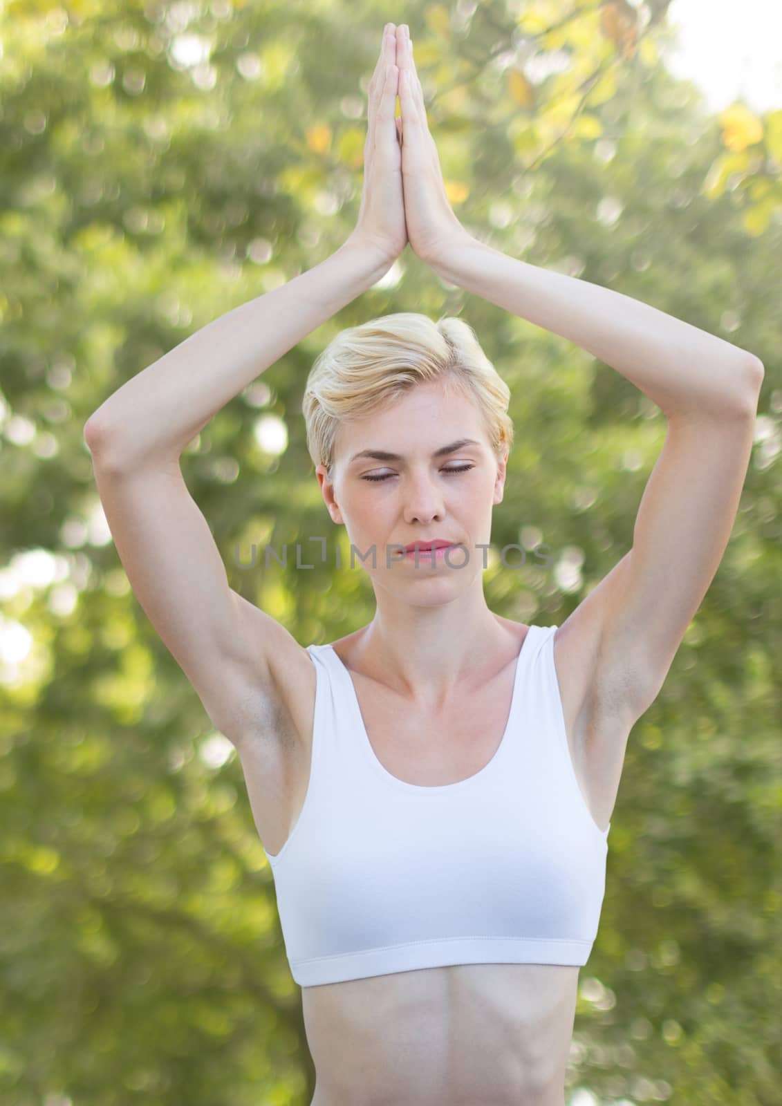 Digital composite of Woman doing yoga Meditating by trees