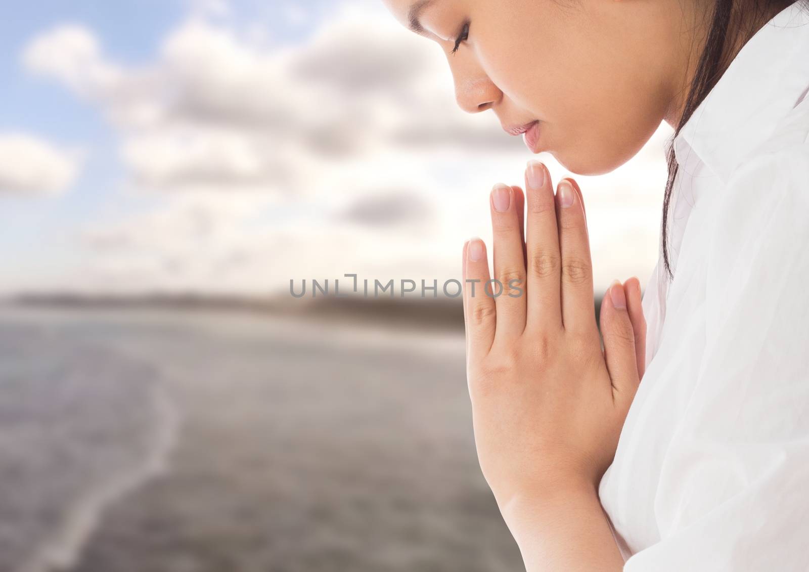 Digital composite of Woman praying Yoga Meditating by sea