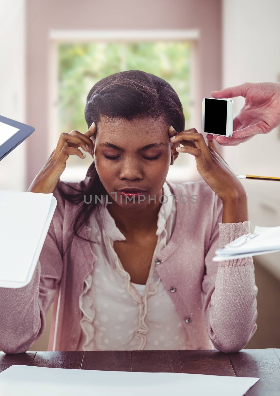 Digital composite of Stressed woman at desk surrounded by nuisances of technology and paperwork