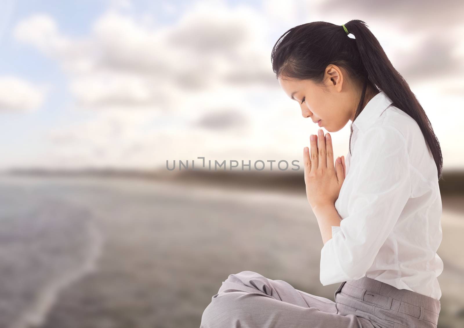 Digital composite of Woman Praying yoga Meditating by sea