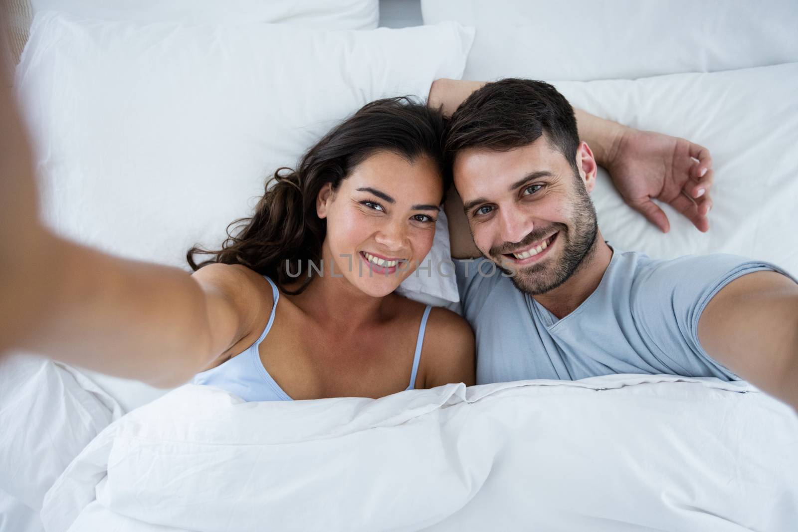 Portrait of romantic couple sleeping on bed in bedroom