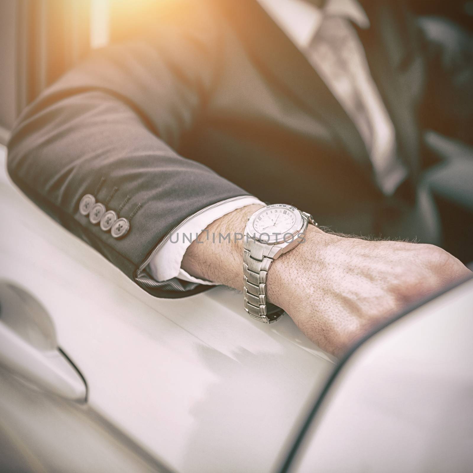 Arm of a man leaning on a car 