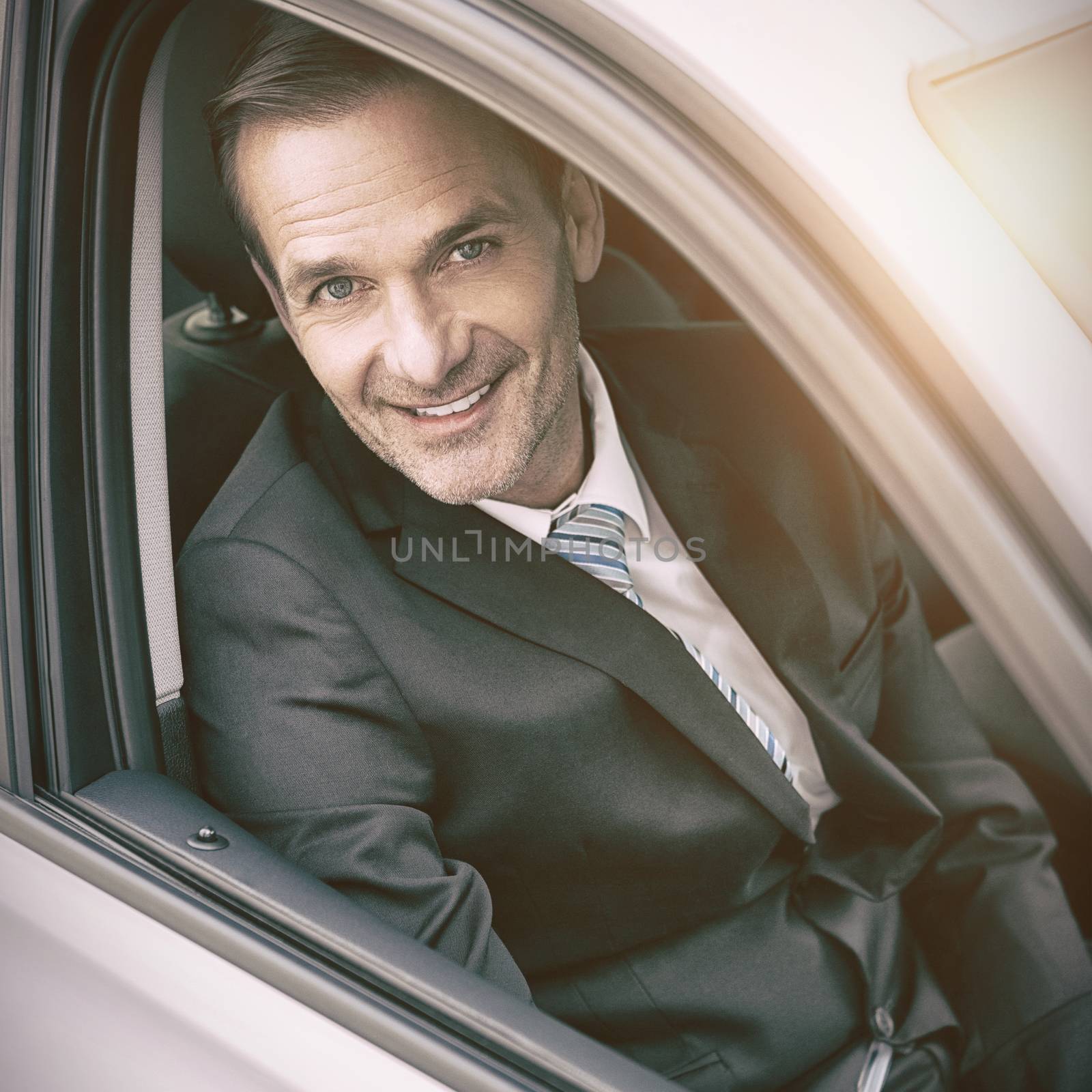 Man sitting in a car looking at camera