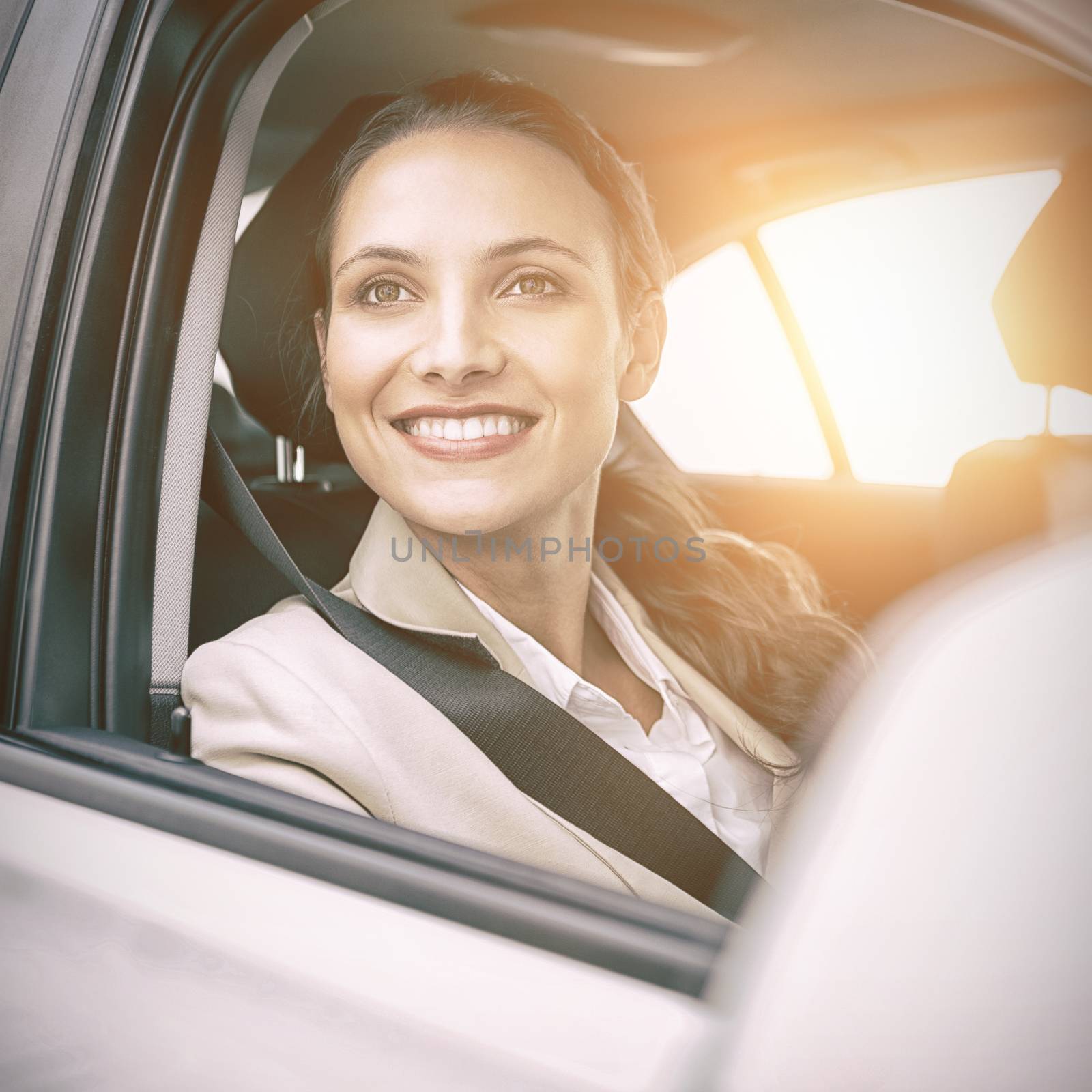 Woman sitting in a car and smiling