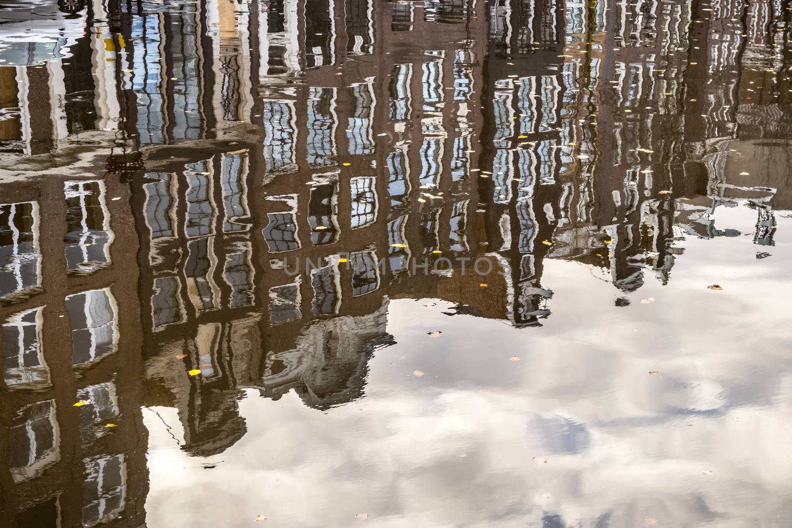 Amstedam, capital of Netherlands. Water reflections of traditional houses by the street canal.