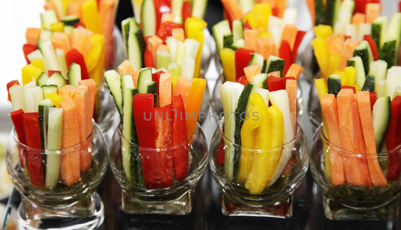 transparent glass with slices of fresh vegetables