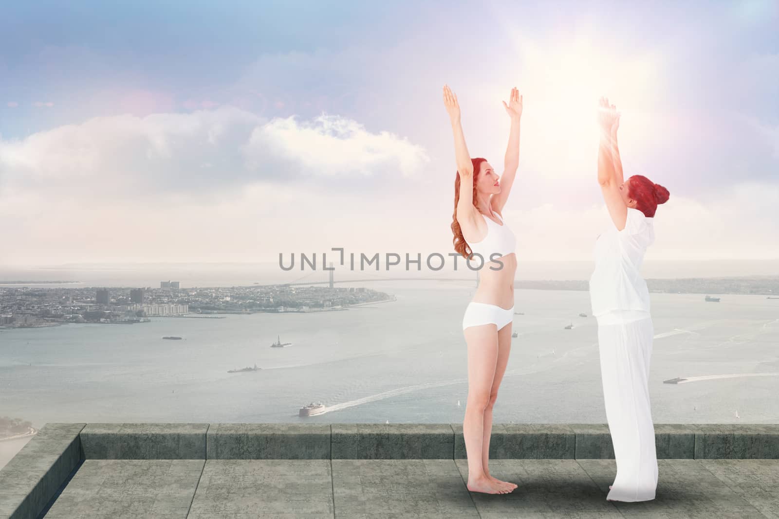 Relaxed women doing yoga  against coastline city