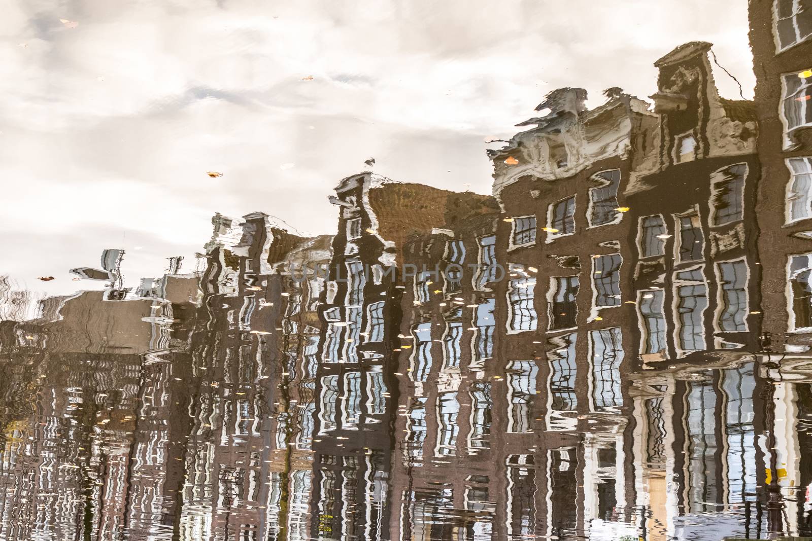 Amstedam, capital of Netherlands. Water reflections of traditional houses by the street canal.