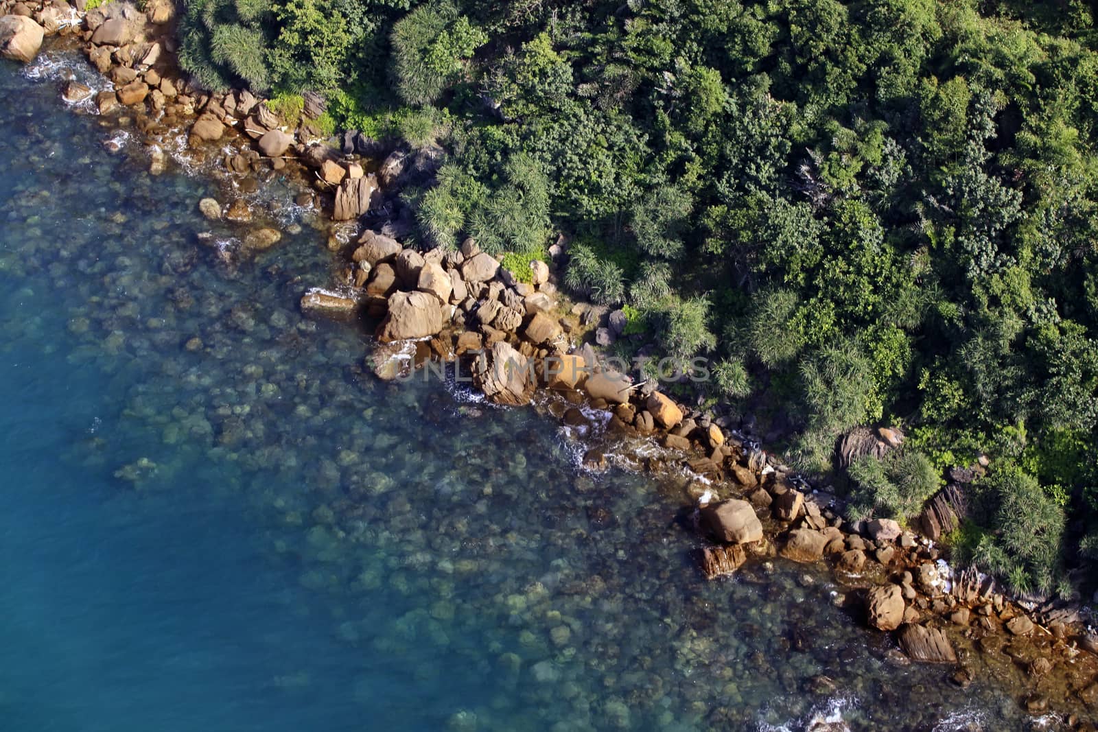 Aerial view of turquoise sea water and rocky coastline. Summer vacation concept. Vietnam, Phu Quoc