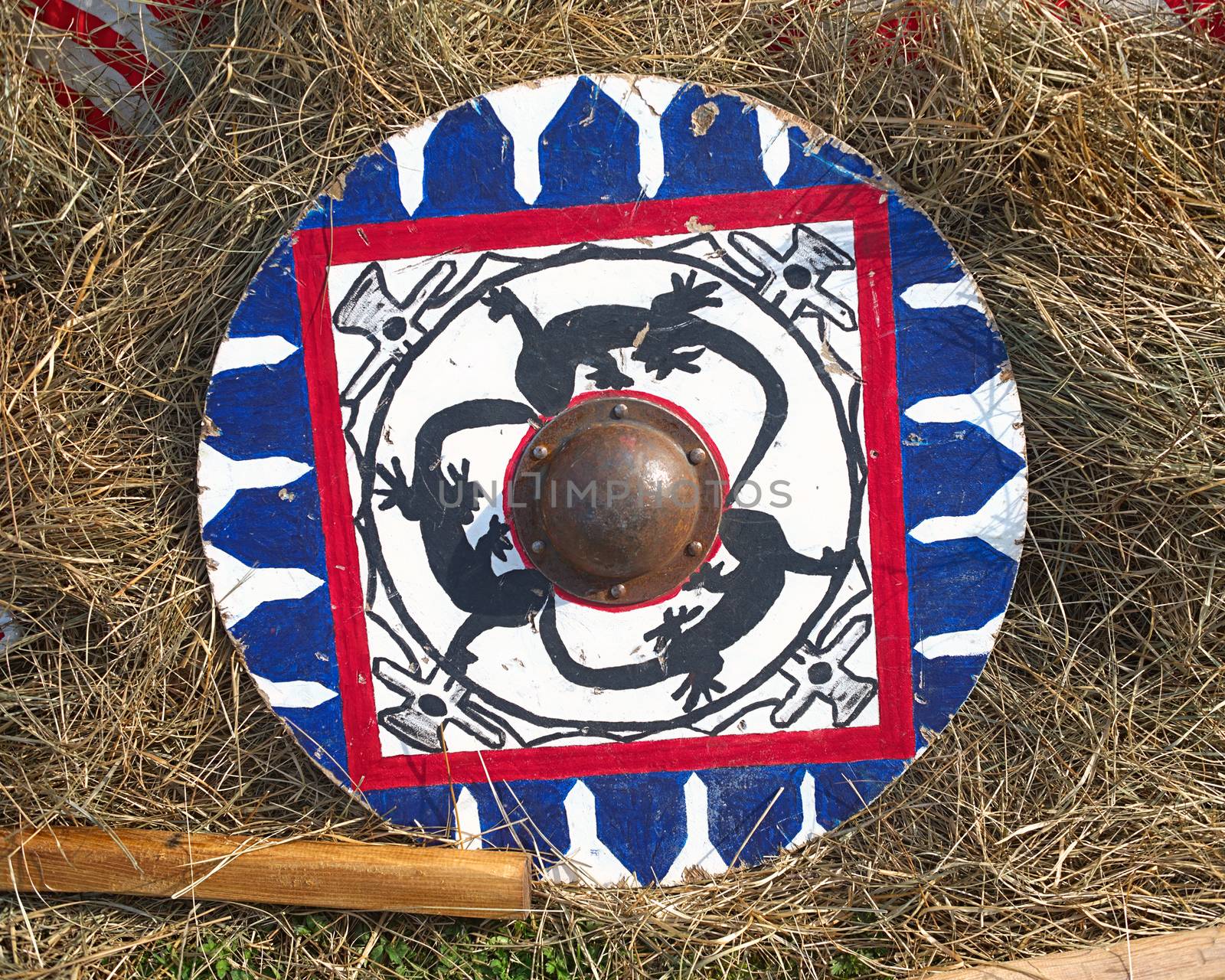 Medieval round wooden shield on hay by sheriffkule