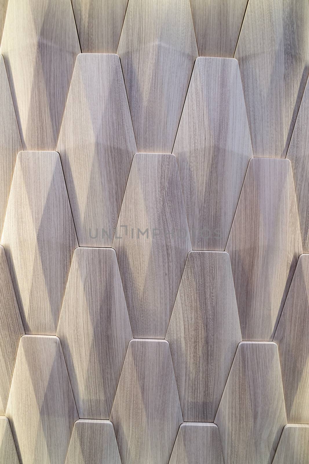 3D decorative wall with imitation wood texture for the interior of an unusual geometric shape. Gray-brown light background with a pattern imitating a tree. Abstract texture