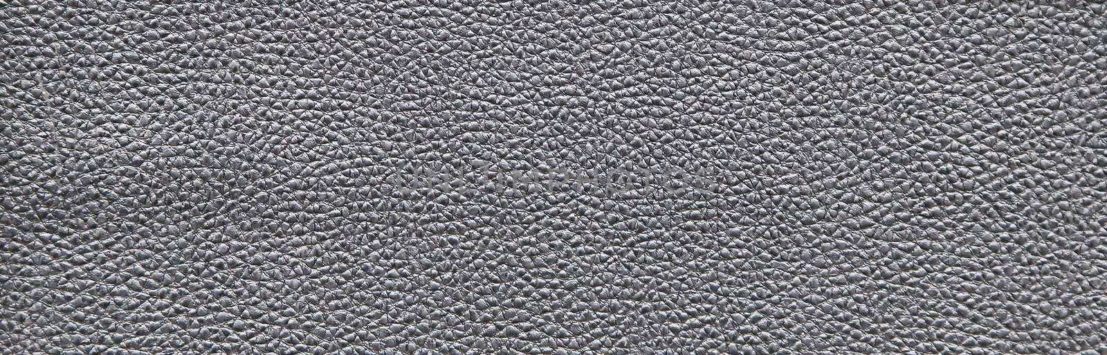 Dark gray abstract rough decorative texture imitating leather. Textured paper with copy space. Graphite color paper surface, texture closeup.