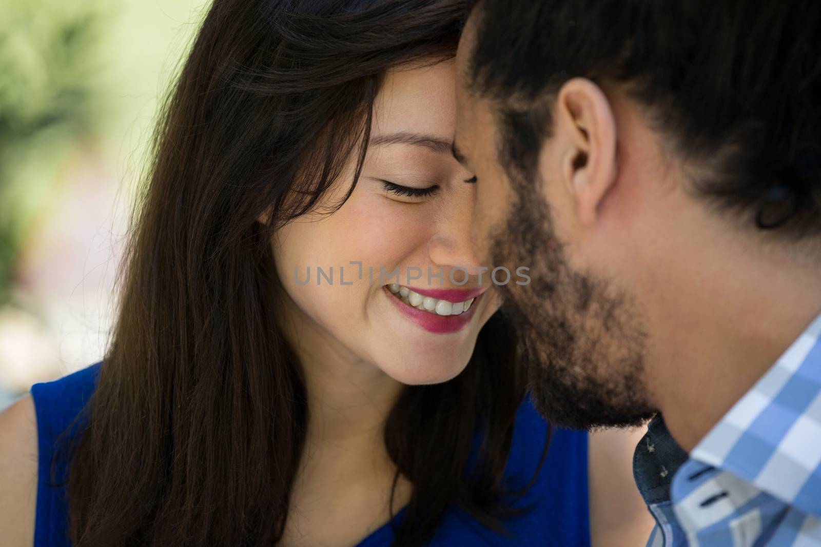 Close-up of romantic young couple in park