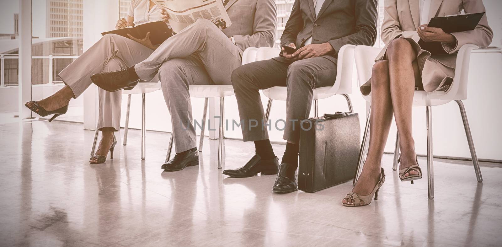 Business people sitting in waiting room by Wavebreakmedia