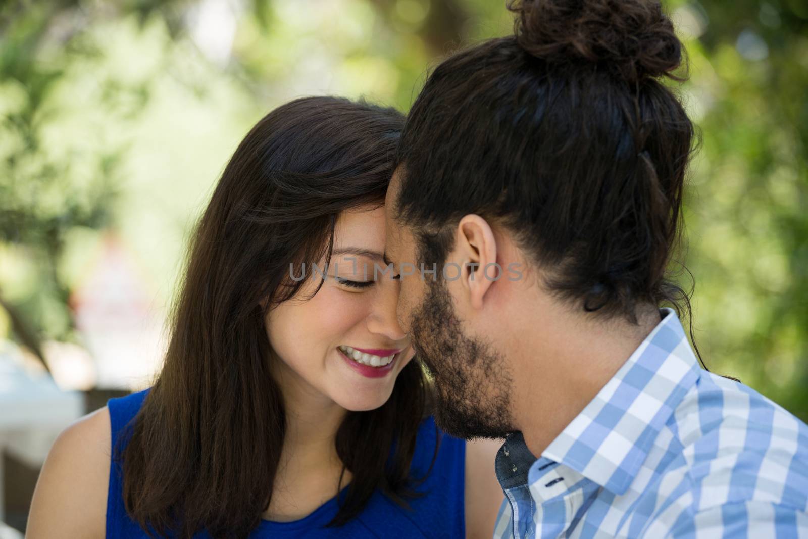 Close-up of romantic young couple spending leisure time in park