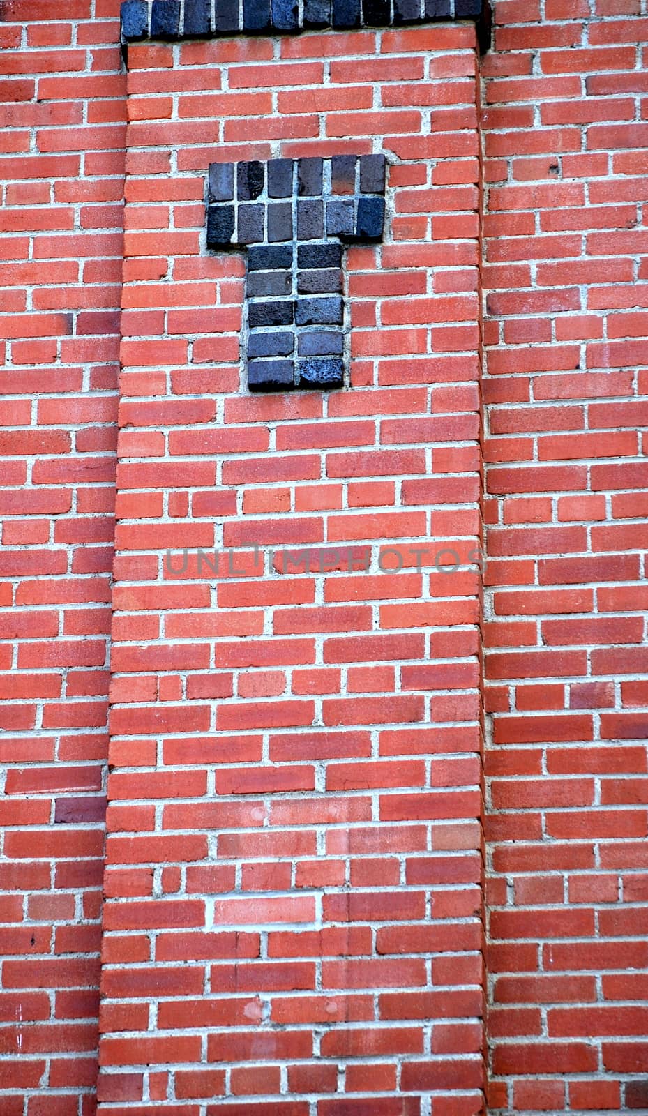 Red brick wall abstract standing tall outside.