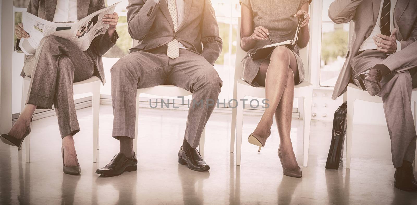 Business people sitting on chairs by Wavebreakmedia
