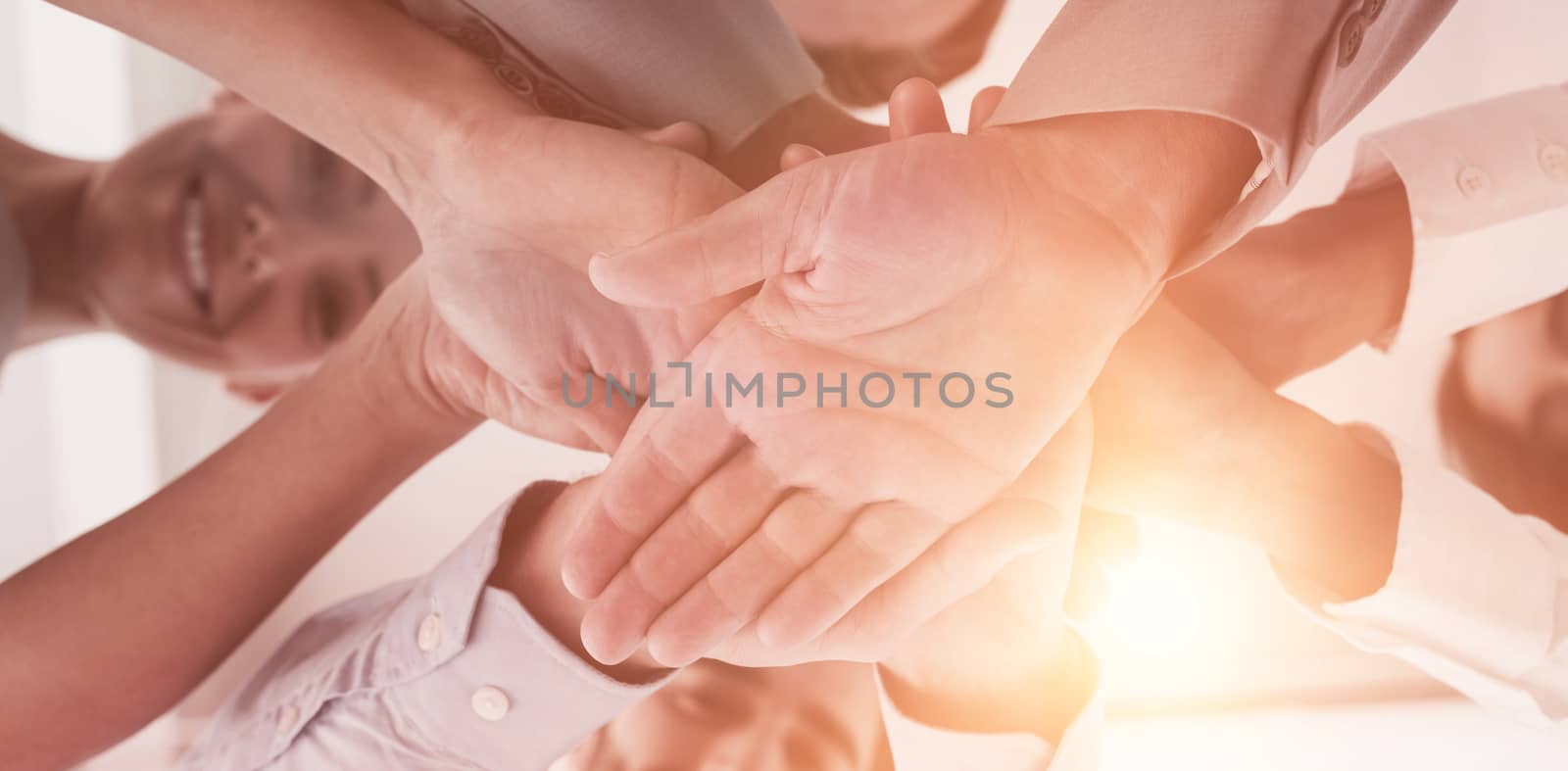 Close-up of business people staking hand at office