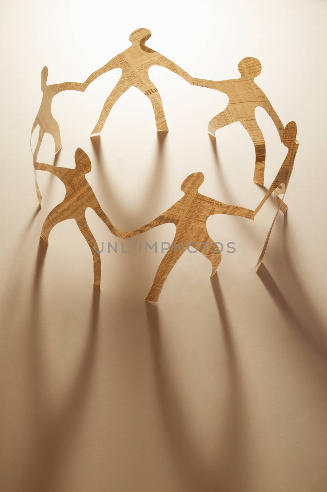 Paper dolls holding hands by conceptualmotion