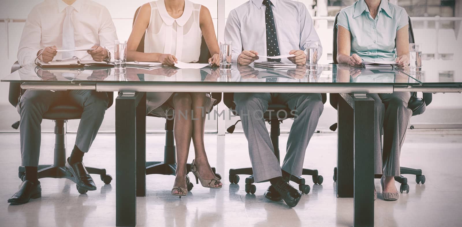 Group of business people sitting at table in office