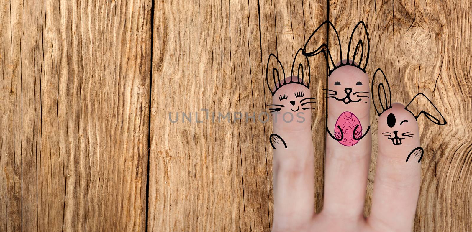 Vector image of fingers painted as Easter bunny  against close-up of wooden texture