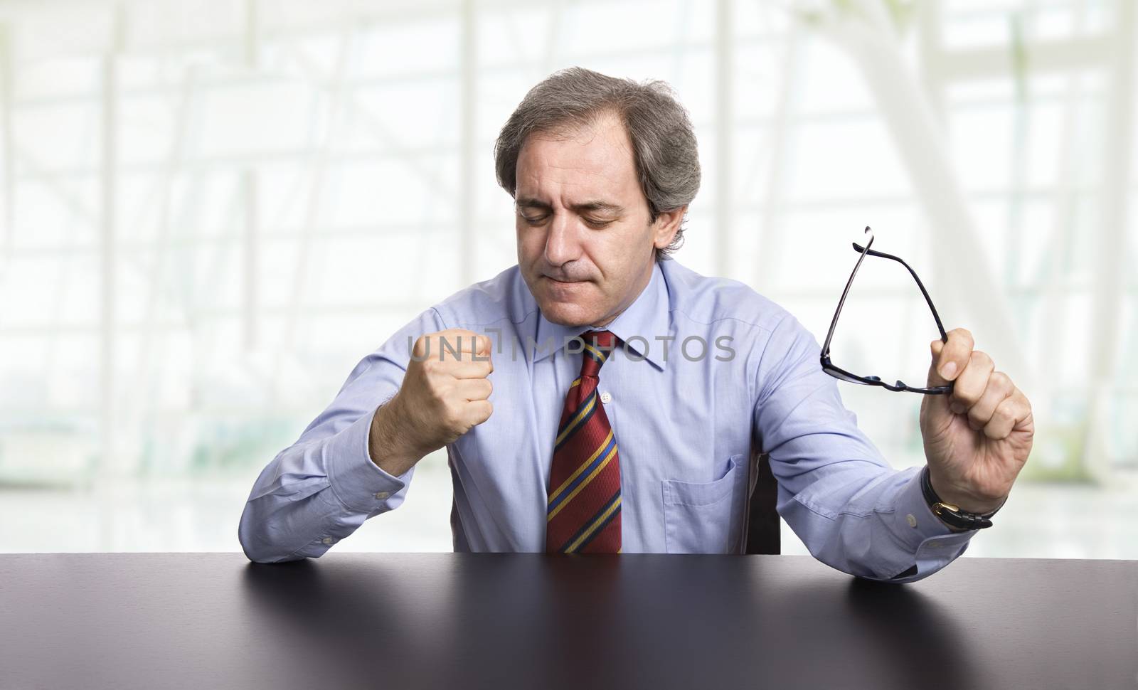 mature business man on a desk, at the office