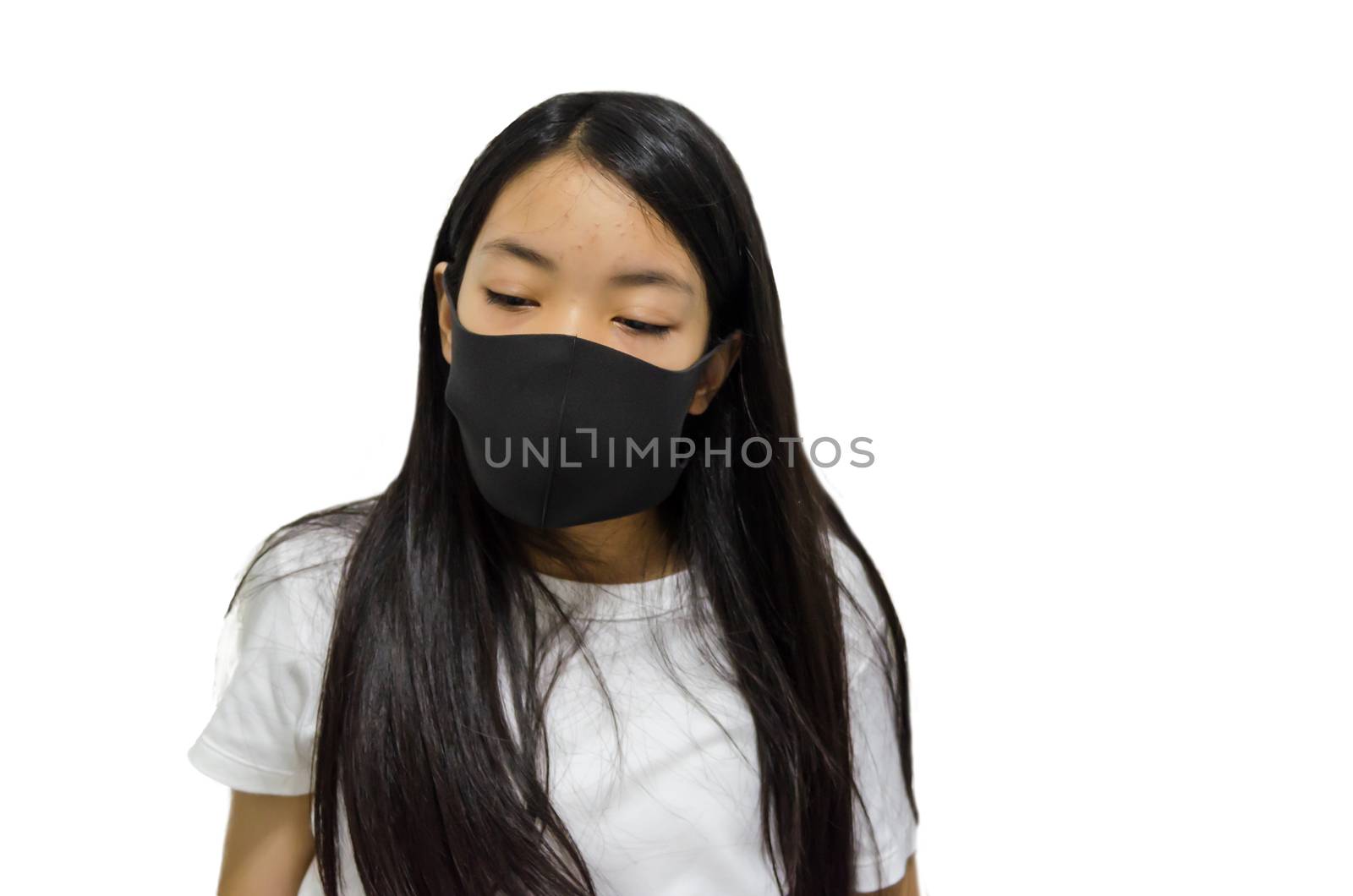 An Asian long haired girl wearing a black mask is ill with the flu. On a white background. Clipping path