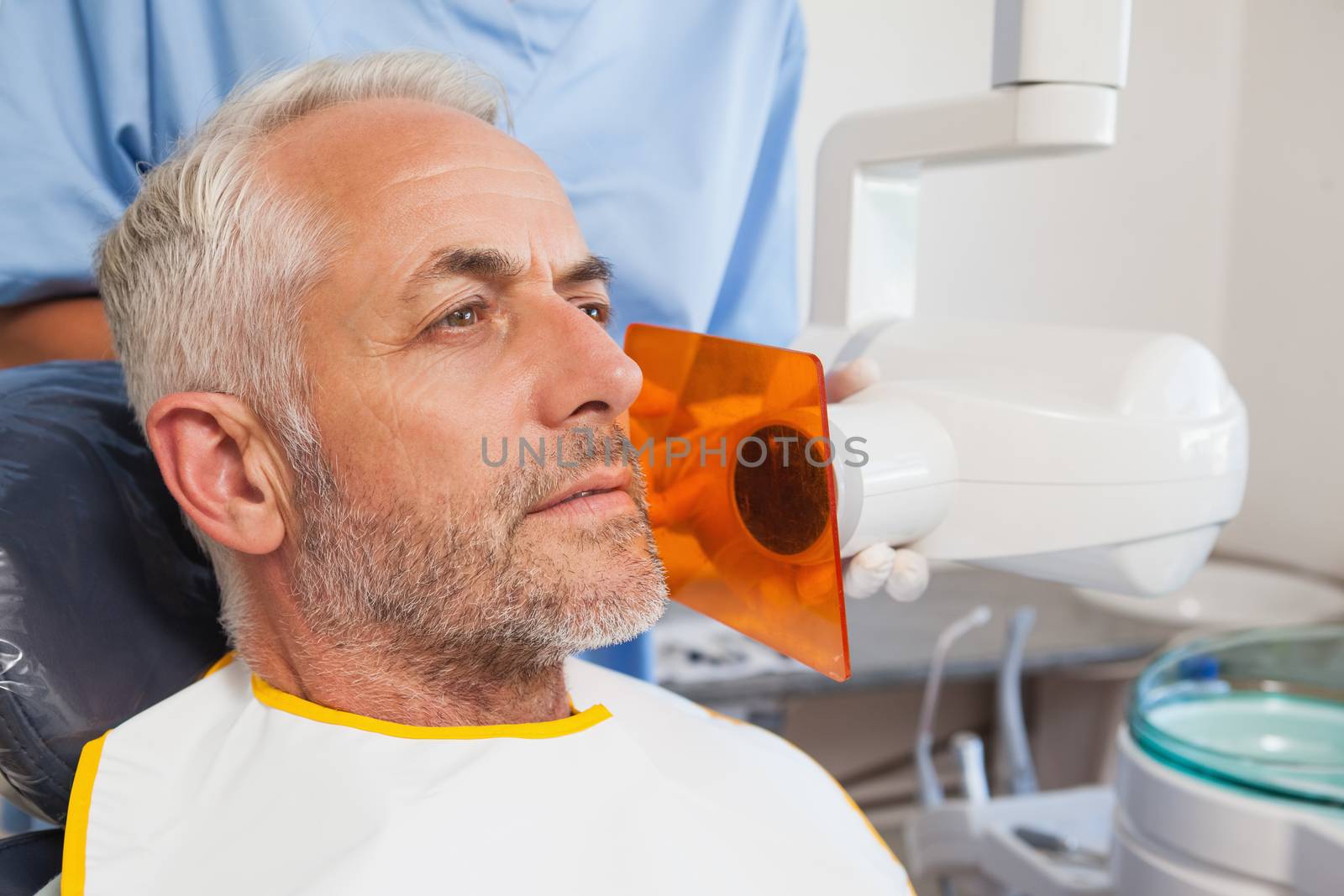 Dentist taking an xray of patients mouth at the dental clinic