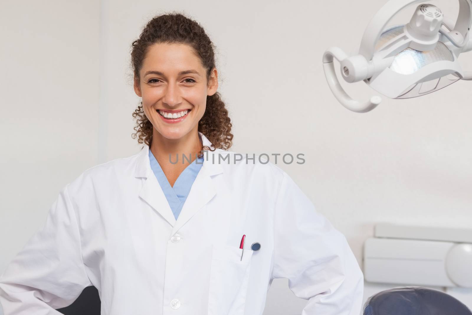Confident dentist smiling at the camera at the dental clinic