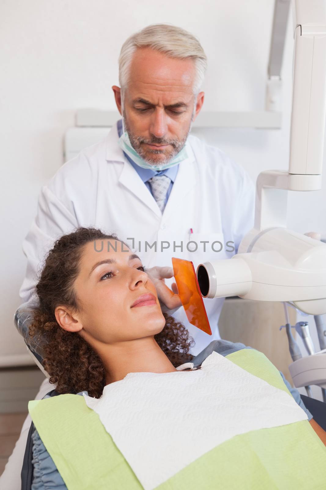 Dentist taking an xray of patients mouth by Wavebreakmedia