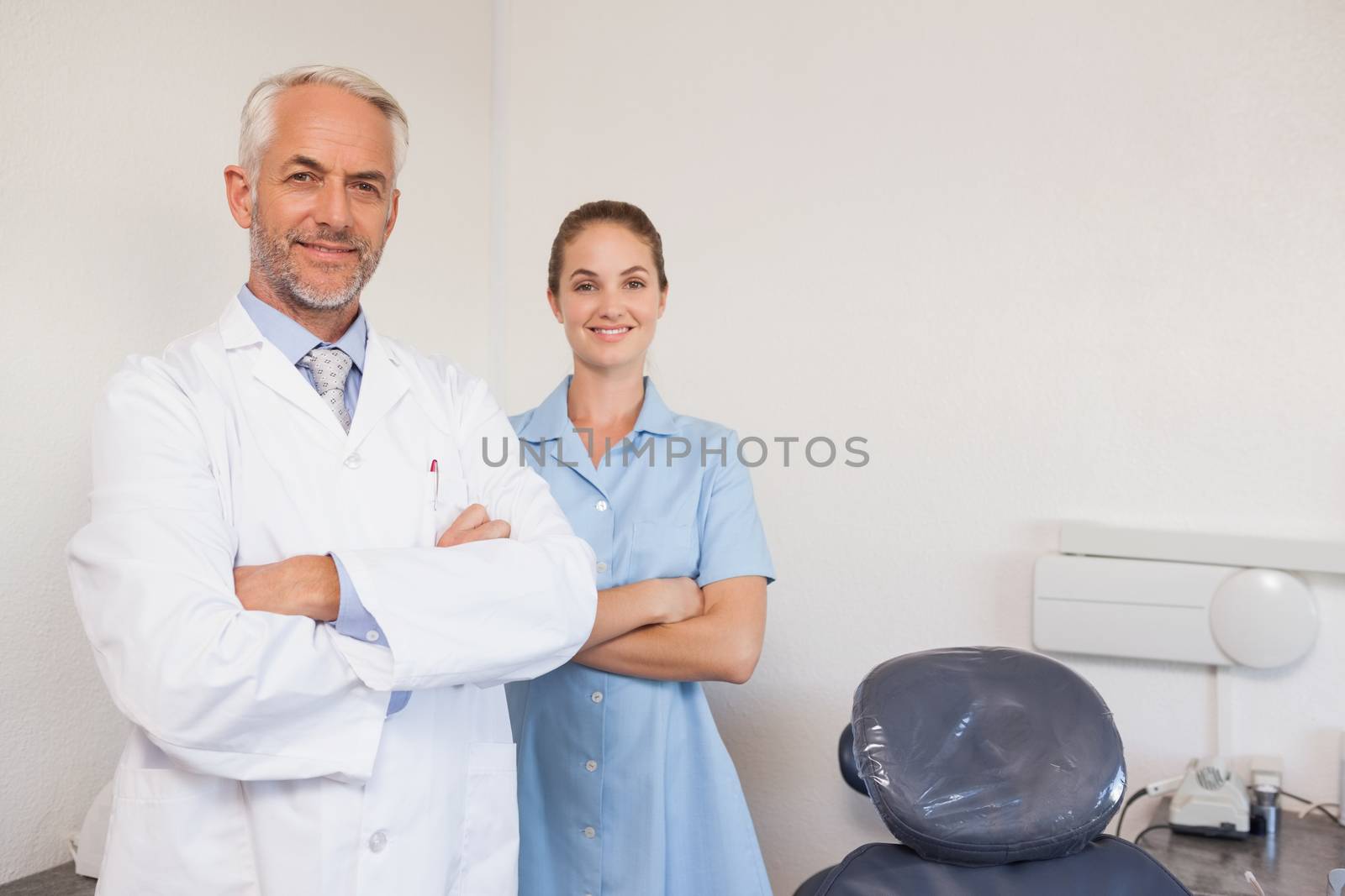 Dentist and assistant smiling at camera by Wavebreakmedia