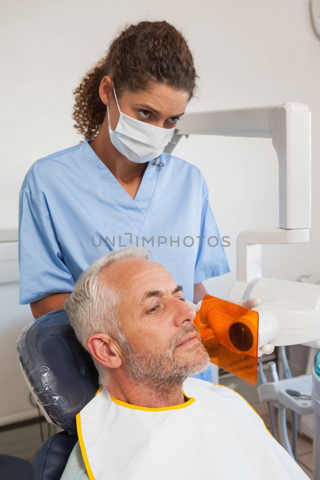 Dentist taking an xray of patients mouth by Wavebreakmedia