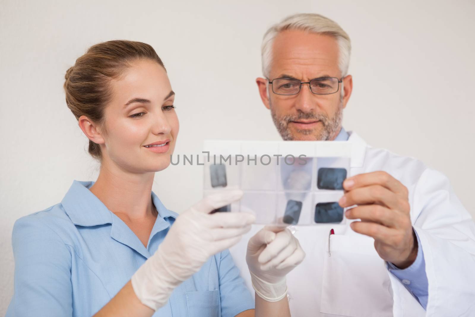 Dentist and assistant studying x-rays by Wavebreakmedia