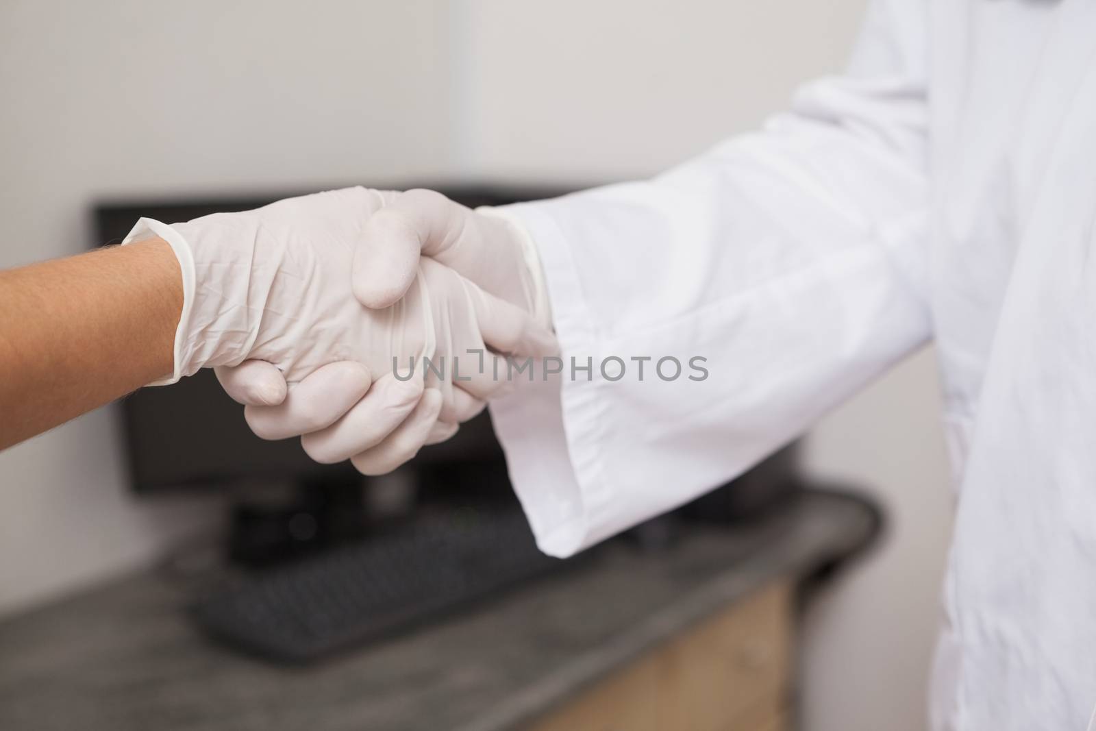 Dentist shaking hands with his patient at the dental clinic