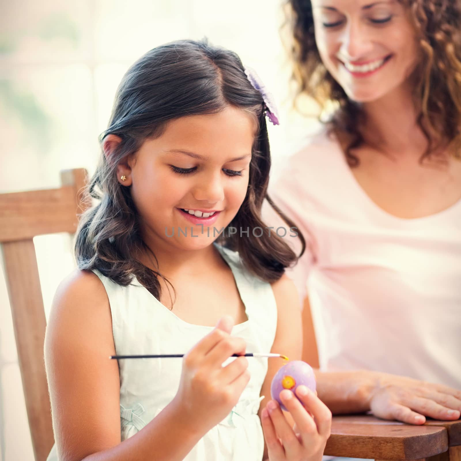 Happy mother and daughter painting easter eggs  by Wavebreakmedia