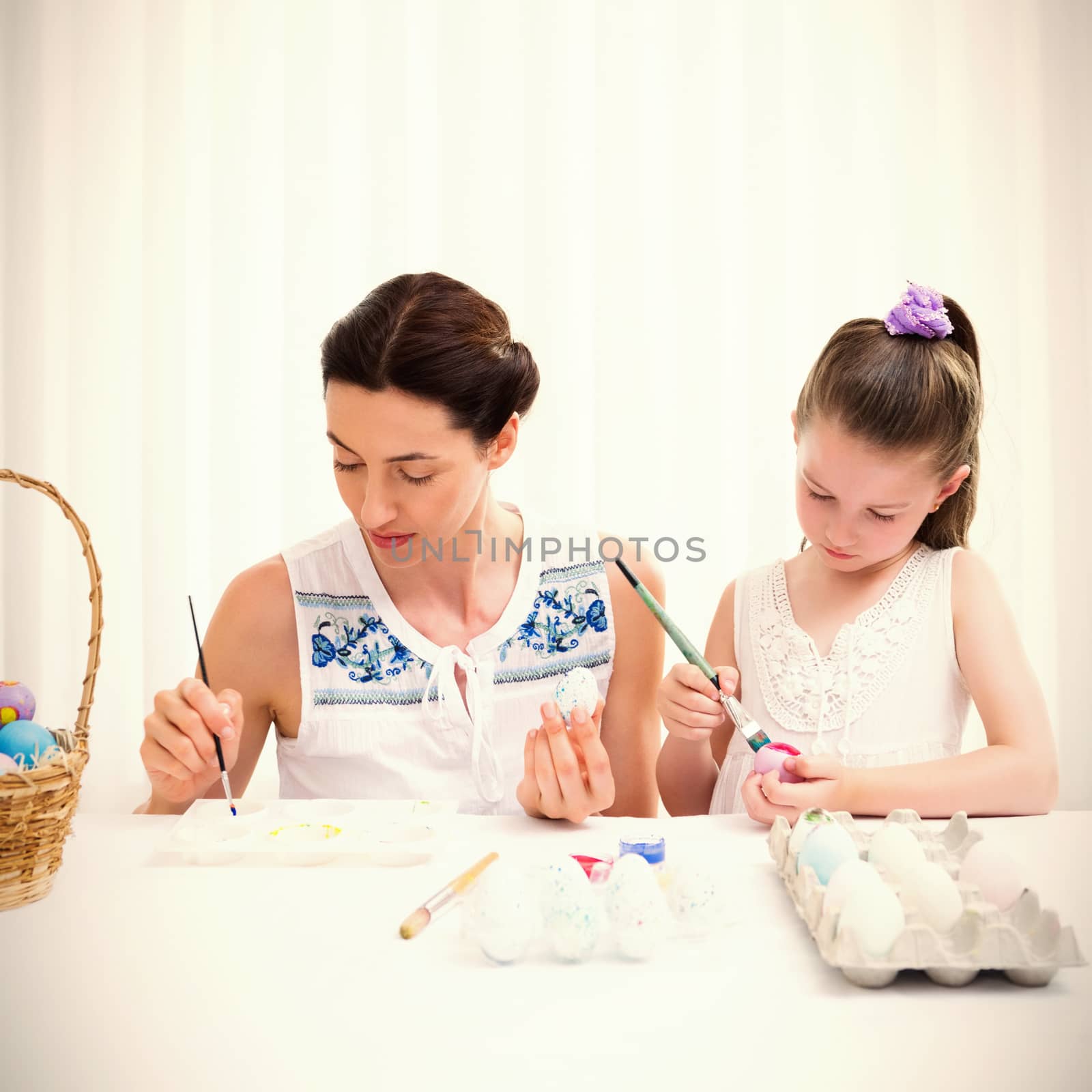 Mother and daughter painting easter eggs by Wavebreakmedia