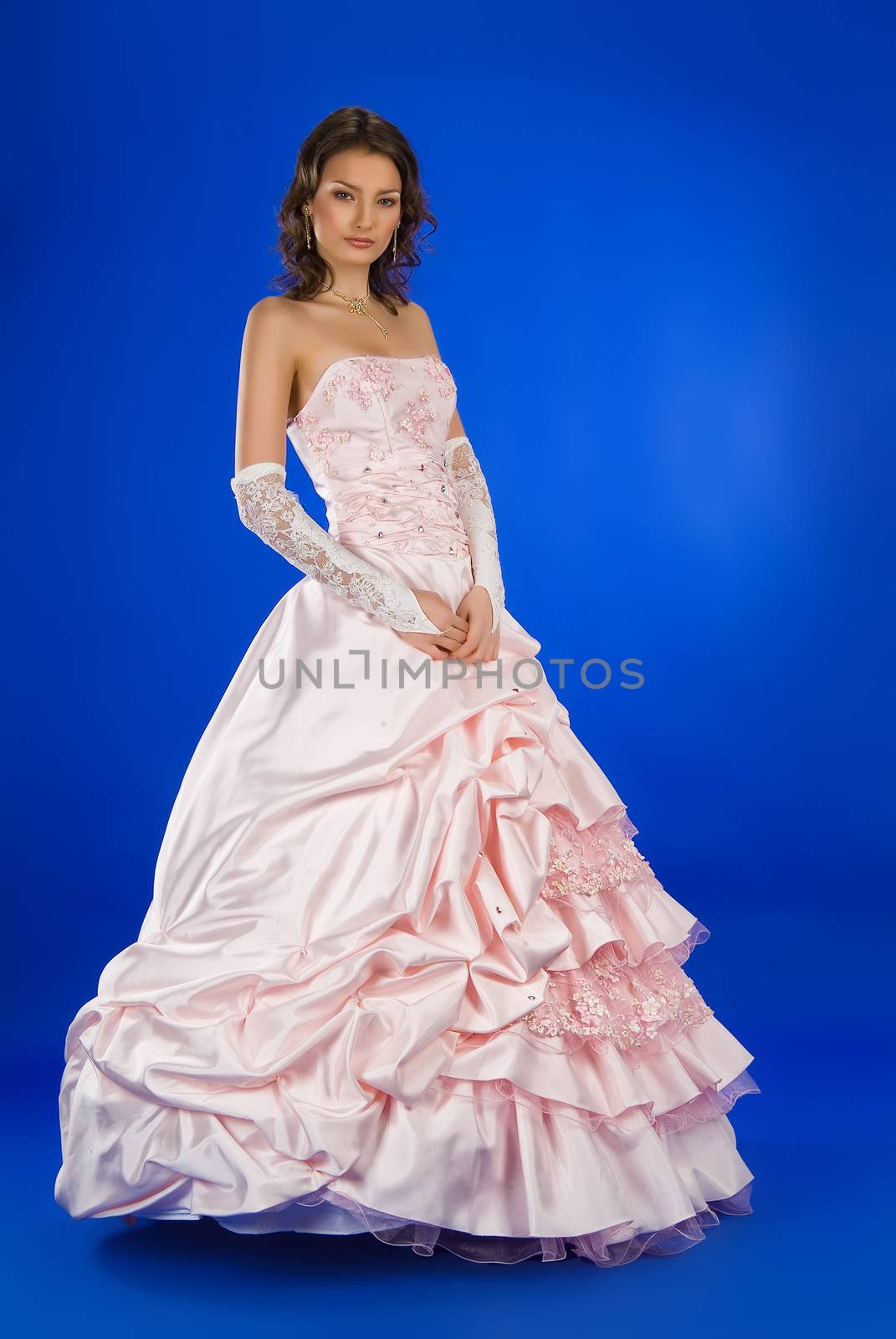 Young beautiful women in wedding dresses on a studio background