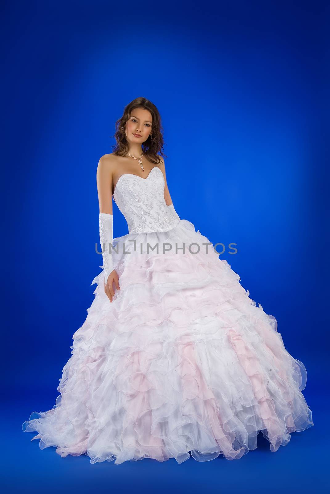 Young beautiful women in wedding dresses on a studio background